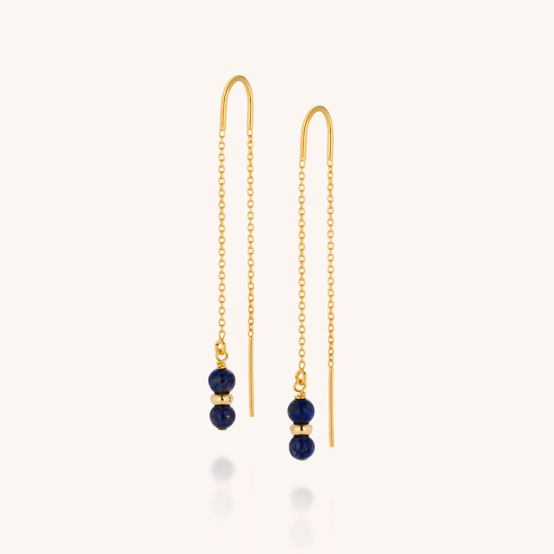 Fall Earrings Birthstone September: Gold chain threader earrings with two small denim-blue Lapis lazuli beads and a gold spacer at each chain’s end, displayed against a light background.