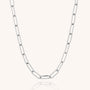 The Paperclip Necklace, crafted from eco silver with elongated rectangular links, is displayed on a plain light background. Its gentle curve accentuates the modern, minimalist design.