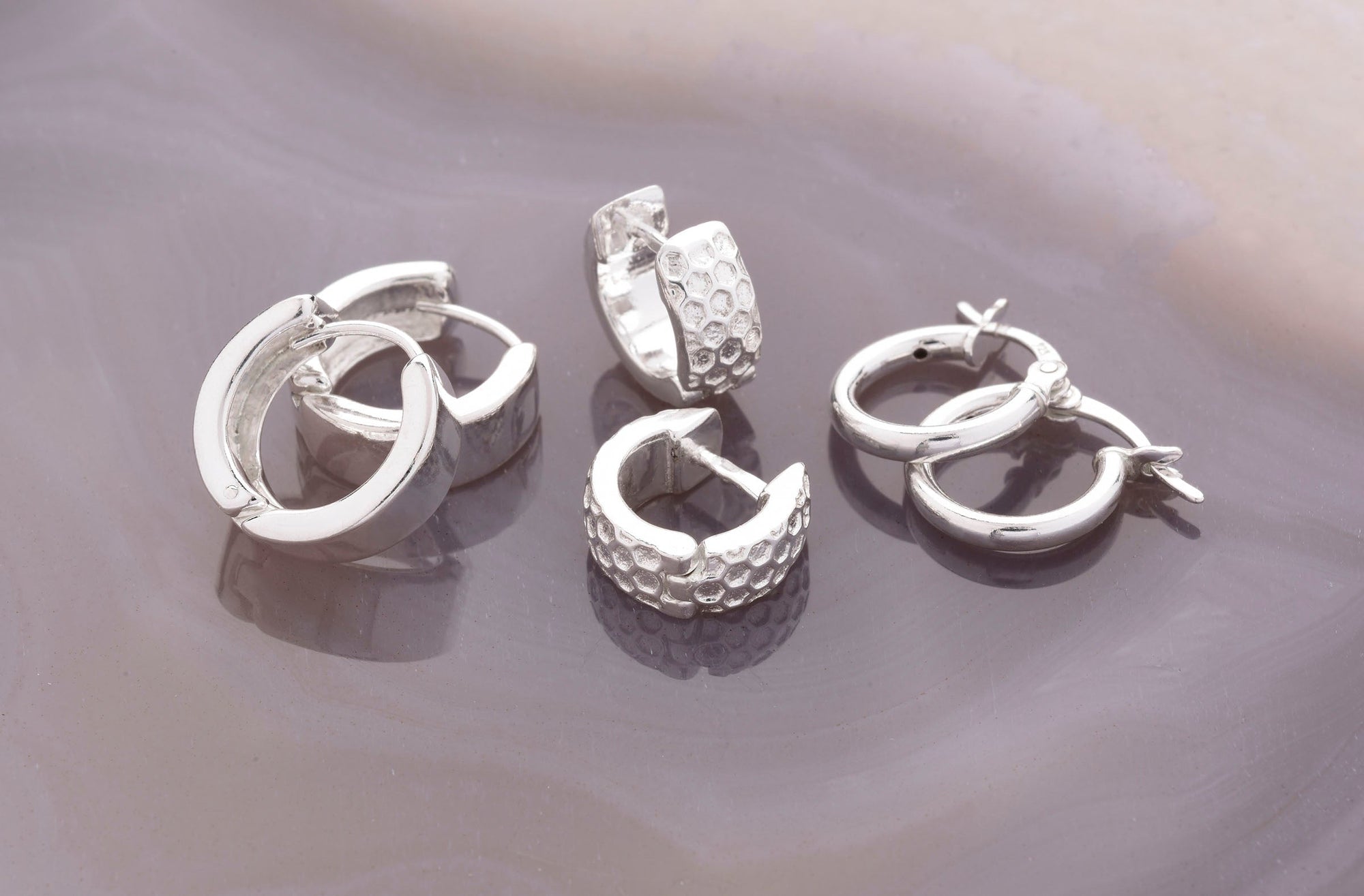 group of three pairs of huggies earrings