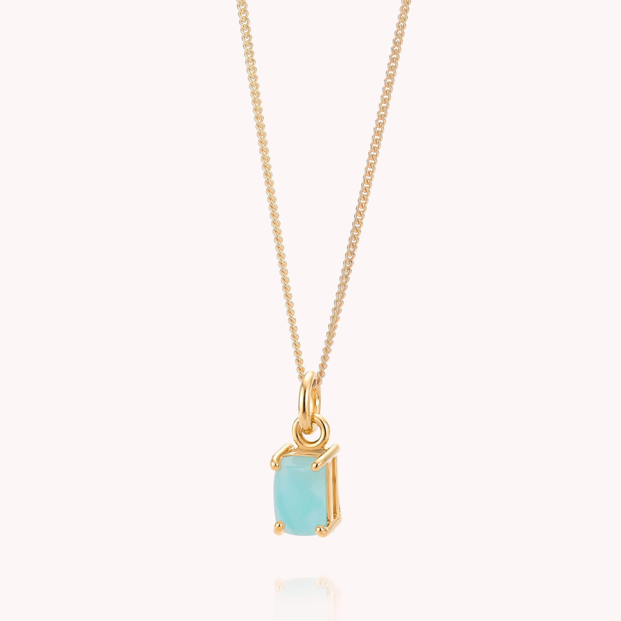 The Amazonite Octavia Necklace features a rectangular light blue amazonite gemstone pendant set in a minimalist gold frame, displayed against a plain light background.