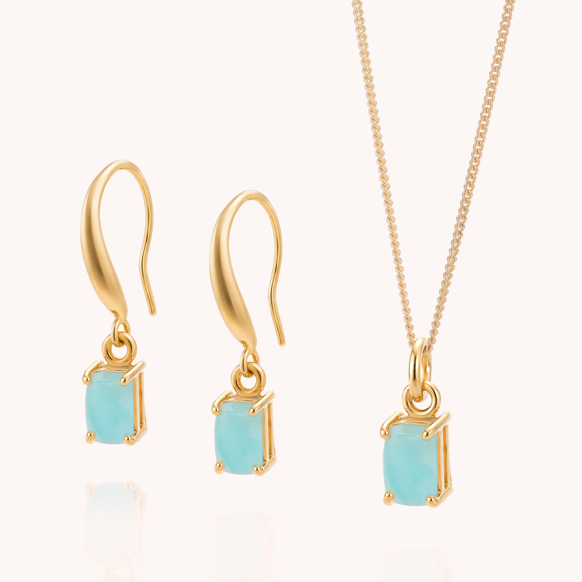 The Amazonite Octavia Necklace &amp; Earrings Set features gold hook earrings and a matching gold necklace, each adorned with a single square-cut, light blue amazonite stone, beautifully displayed against a simple light background.
