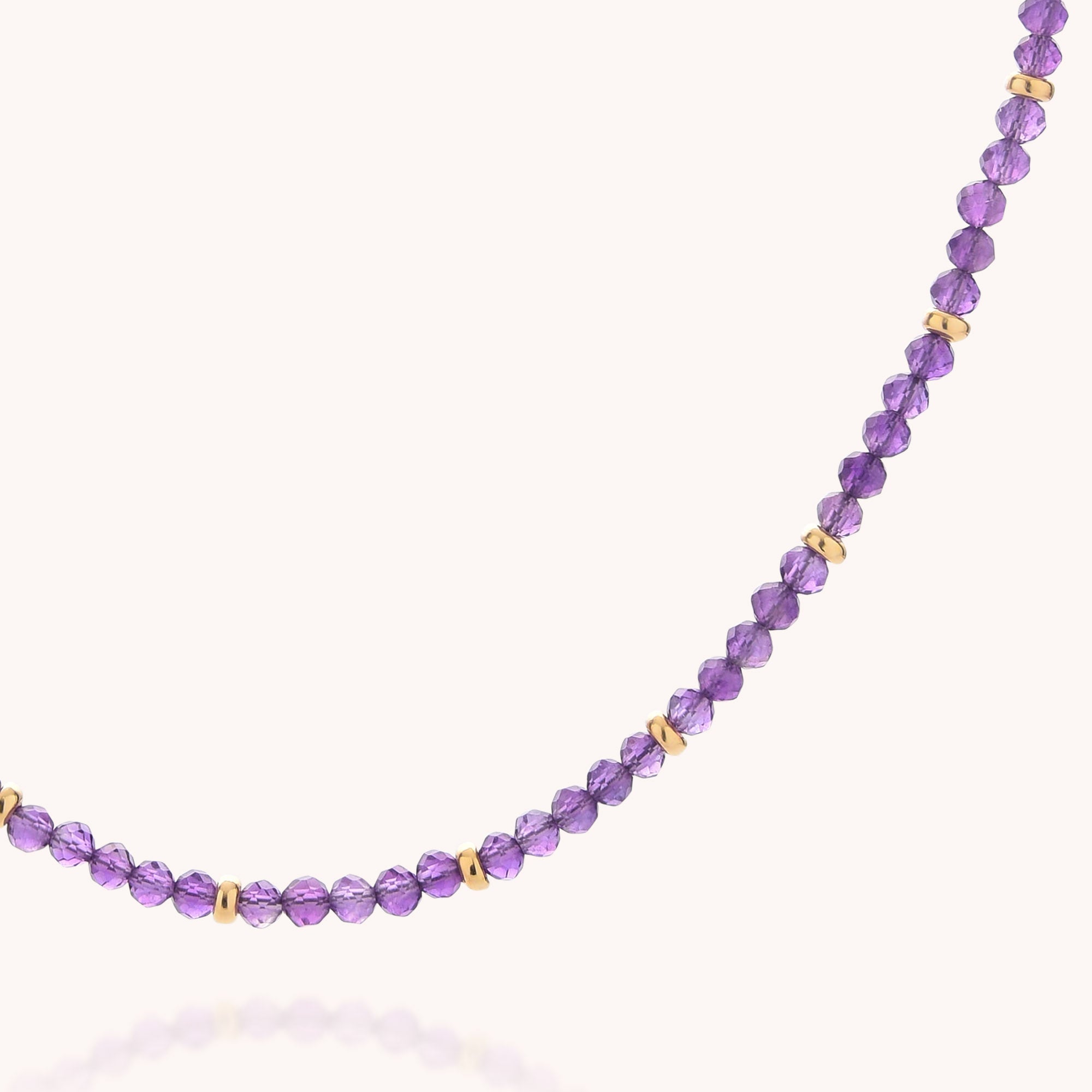 The Amethyst February Birthstone Orbit Necklace features delicate, faceted purple amethyst beads paired with evenly spaced gold-toned round spacers, beautifully displayed against a light background—an ideal piece of handcrafted jewelry and a thoughtful gift for anyone celebrating a February birthday.