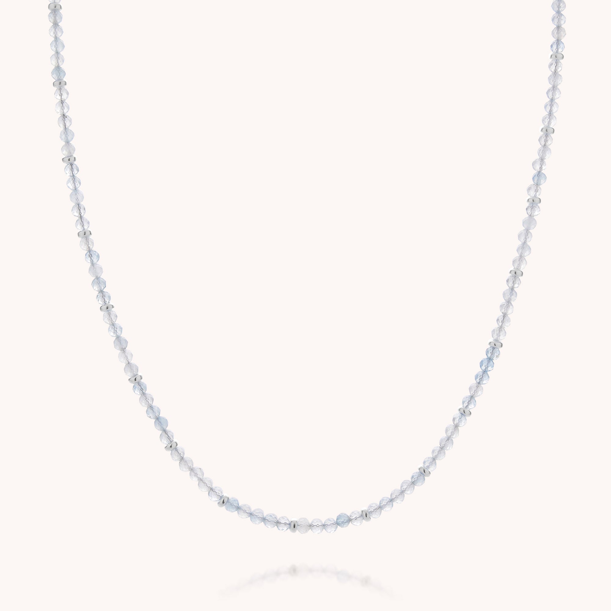 The Aquamarine March Birthstone Orbit Necklace showcases delicate, round, translucent pale blue aquamarine beads evenly spaced along a fine, barely visible string and set against a plain white background—an elegant handcrafted jewelry piece and a beautiful tribute to the March birthstone.