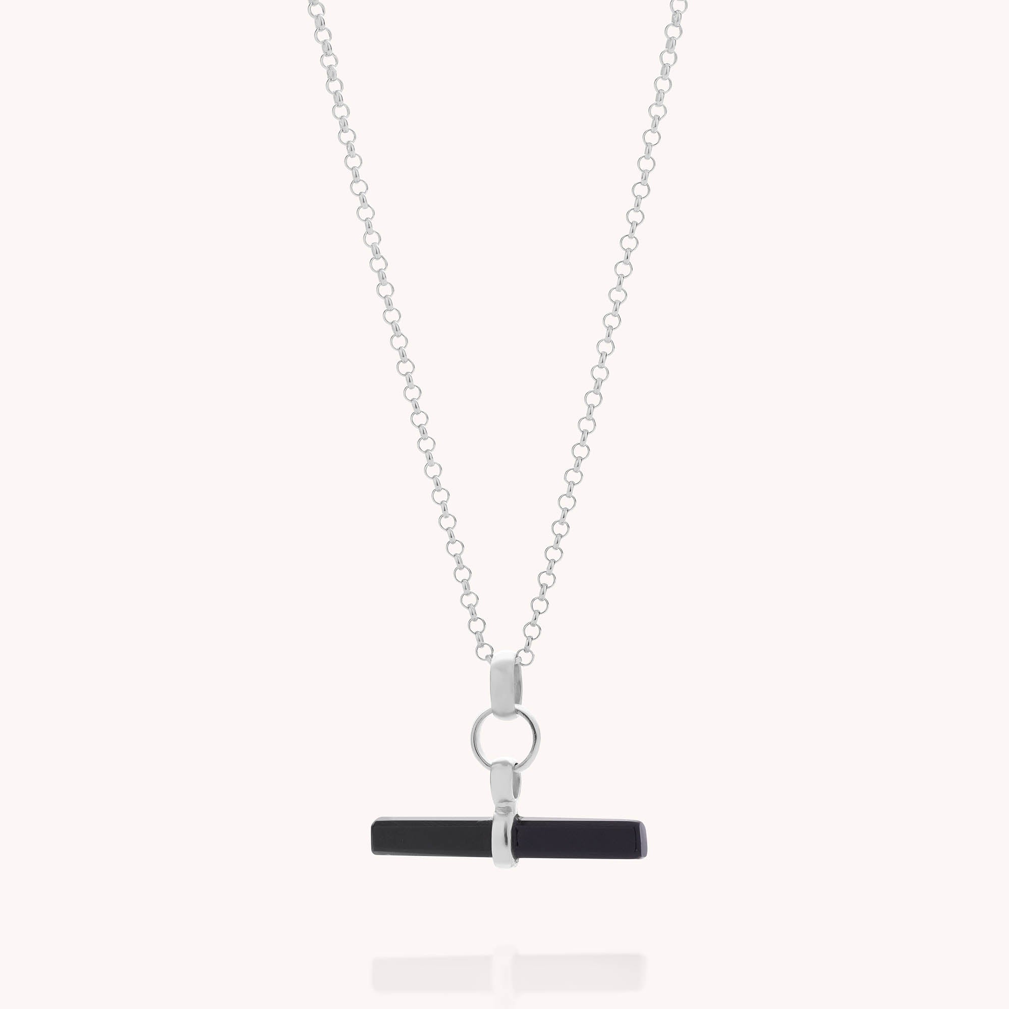 The Gemstone T Bar Necklace features a silver chain with a circular link holding a horizontal black T-bar pendant, showcased on a plain white background.