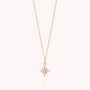 The Celestial Star Necklace is a gold layered piece featuring a delicate chain and a star-shaped pendant embellished with sparkling cubic zirconia gemstones, displayed against a plain white background.