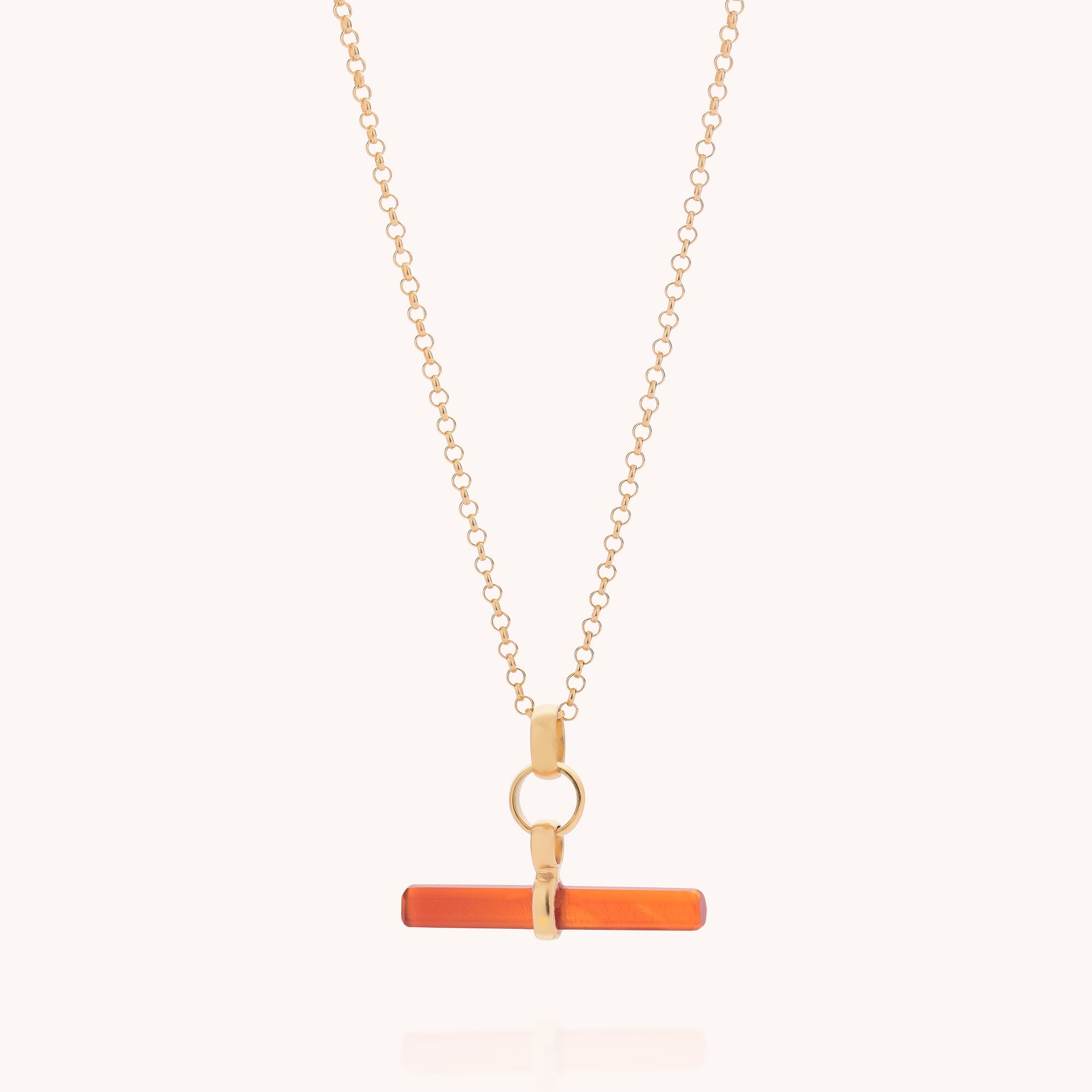 Carnelian T-Bar Necklace—featuring a thin, horizontal orange carnelian bar reminiscent of a T-bar necklace, suspended from a delicate gold chain by a small circular gold loop and displayed on a light background—a refined piece that beautifully blends the essence of gemstone jewellery.