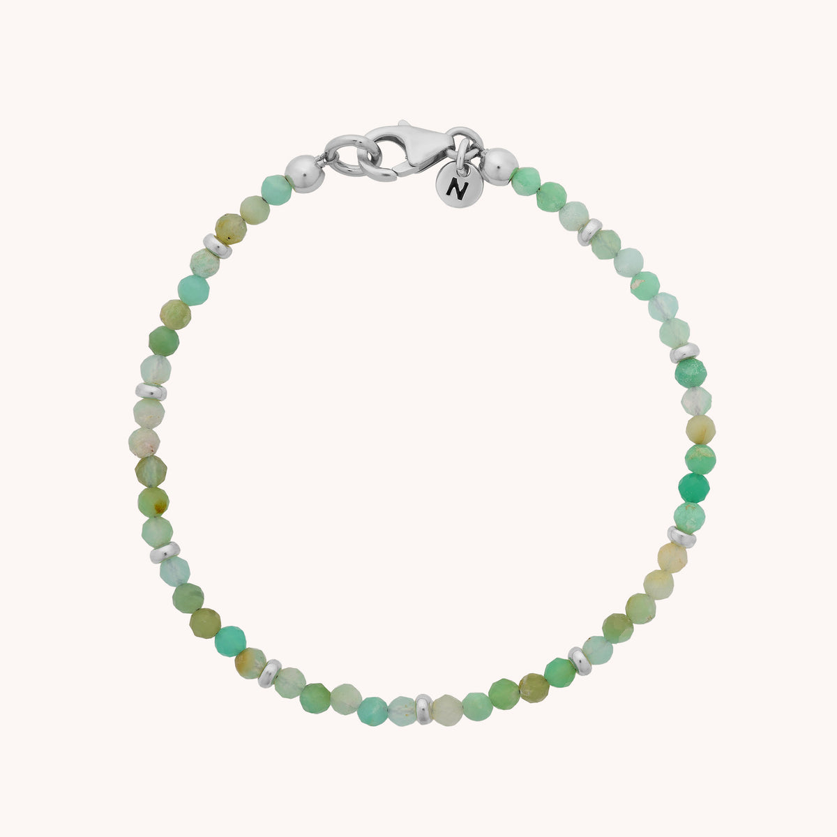 Introducing the Chrysoprase Orbit Bracelet - May: a handcrafted piece featuring small, round green and light blue chrysoprase beads, finished with a silver clasp and a delicate round charm—perfect for lovers of artisan gemstone jewelry.