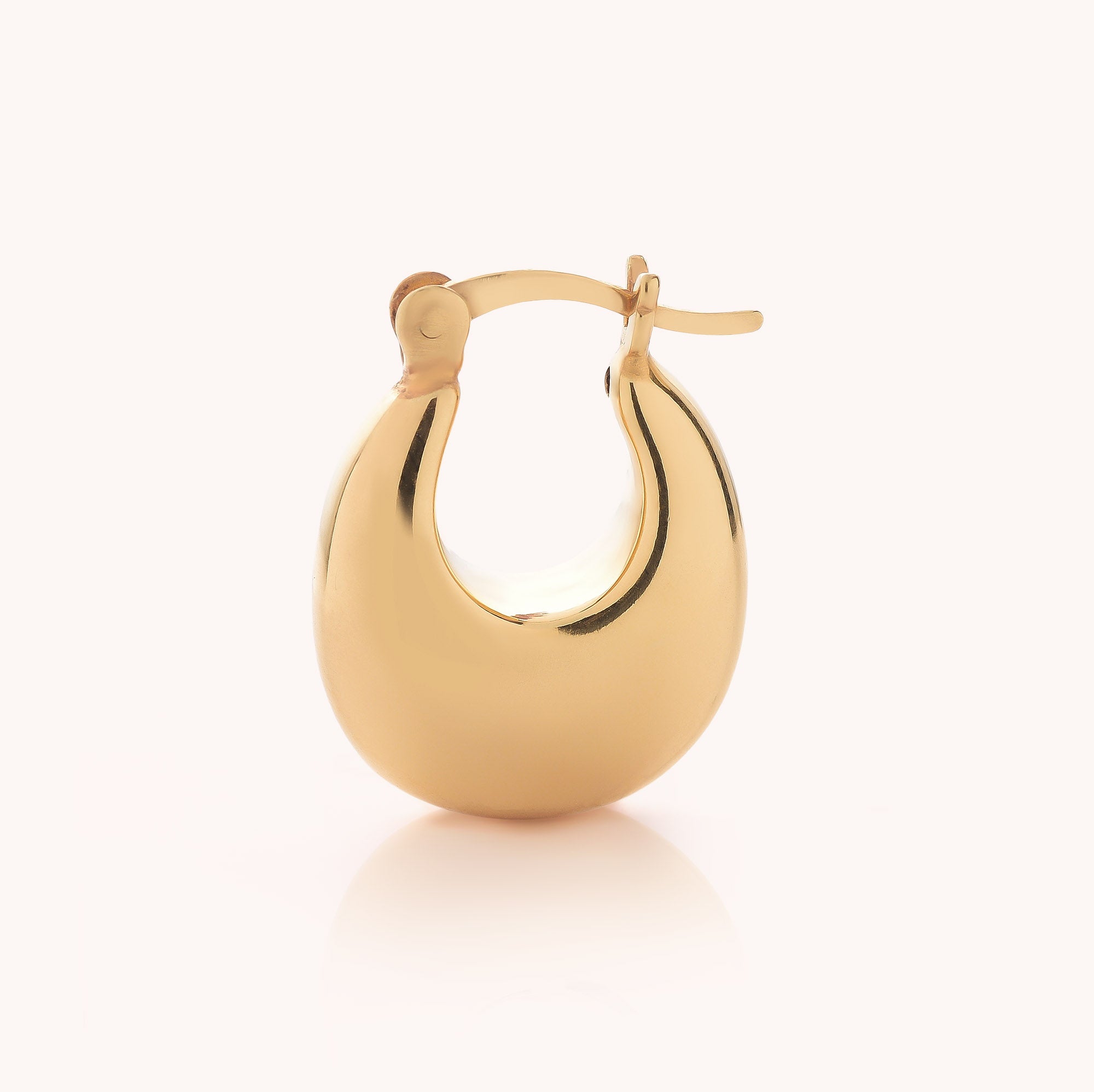 The Dome Hoop Earrings feature a single, shiny gold earring with a rounded, chunky silhouette and an easy hinged clasp, displayed against a plain light background—an ideal way to bring sculptural elegance to your everyday jewelry collection.