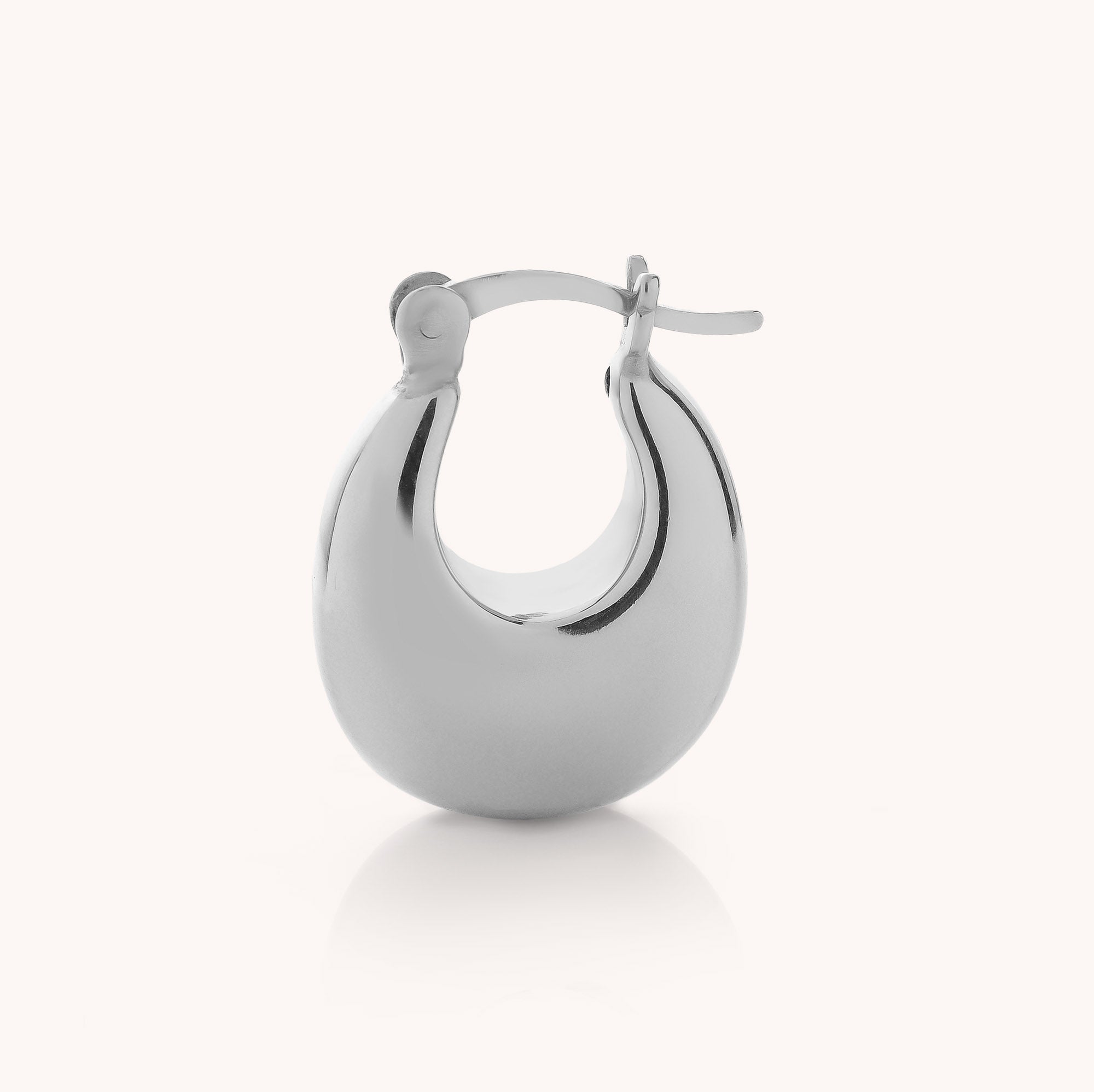 A single Dome Hoop Earring in polished silver, featuring a rounded, chunky silhouette and a secure hinged clasp, displayed against a plain white background—the ideal sculptural piece to elevate your everyday jewelry collection.