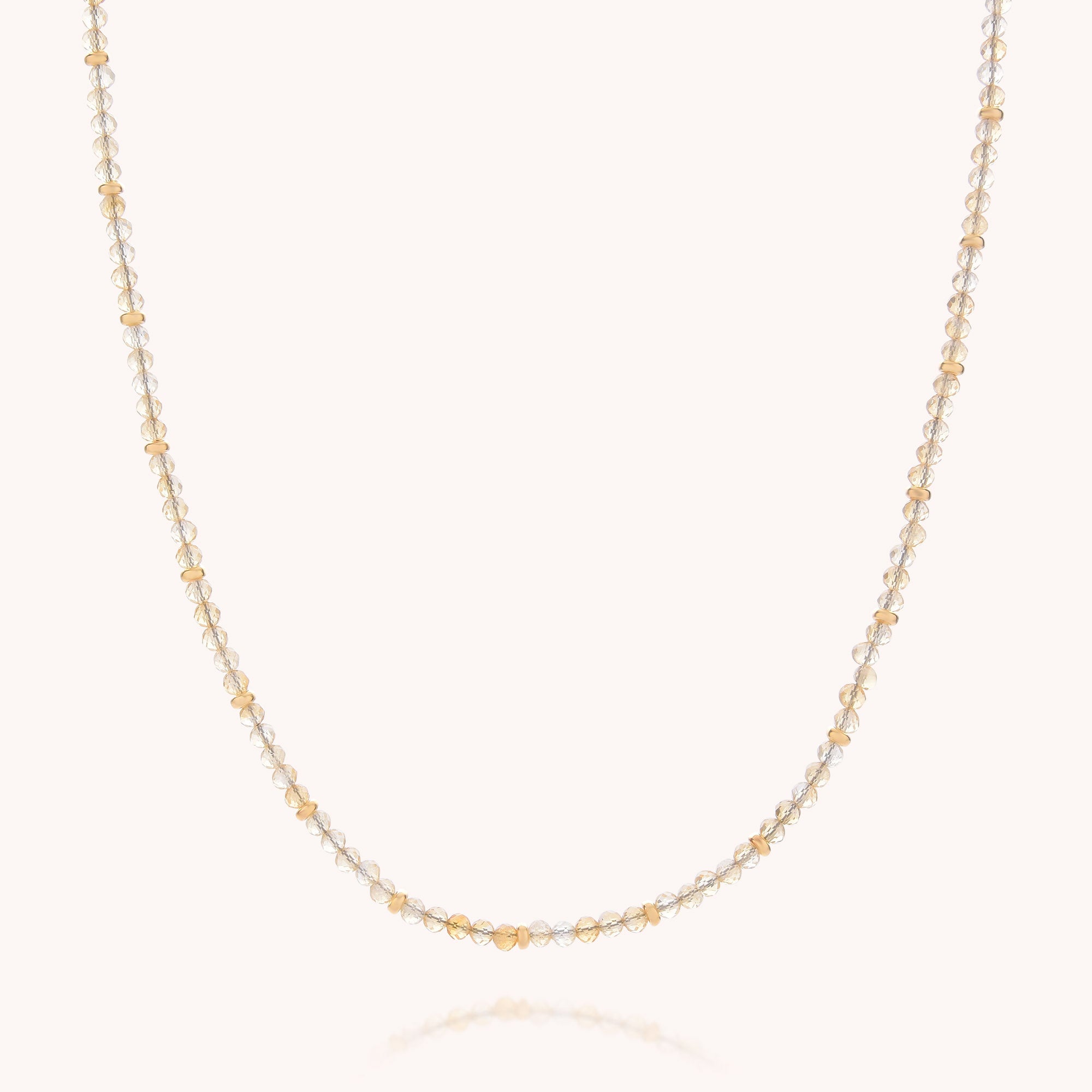 The Citrine November Birthstone Orbit Necklace features alternating small gold and silver beads evenly spaced along a delicate chain, displayed against a plain white background—an elegant piece of handcrafted jewelry perfect for any occasion.