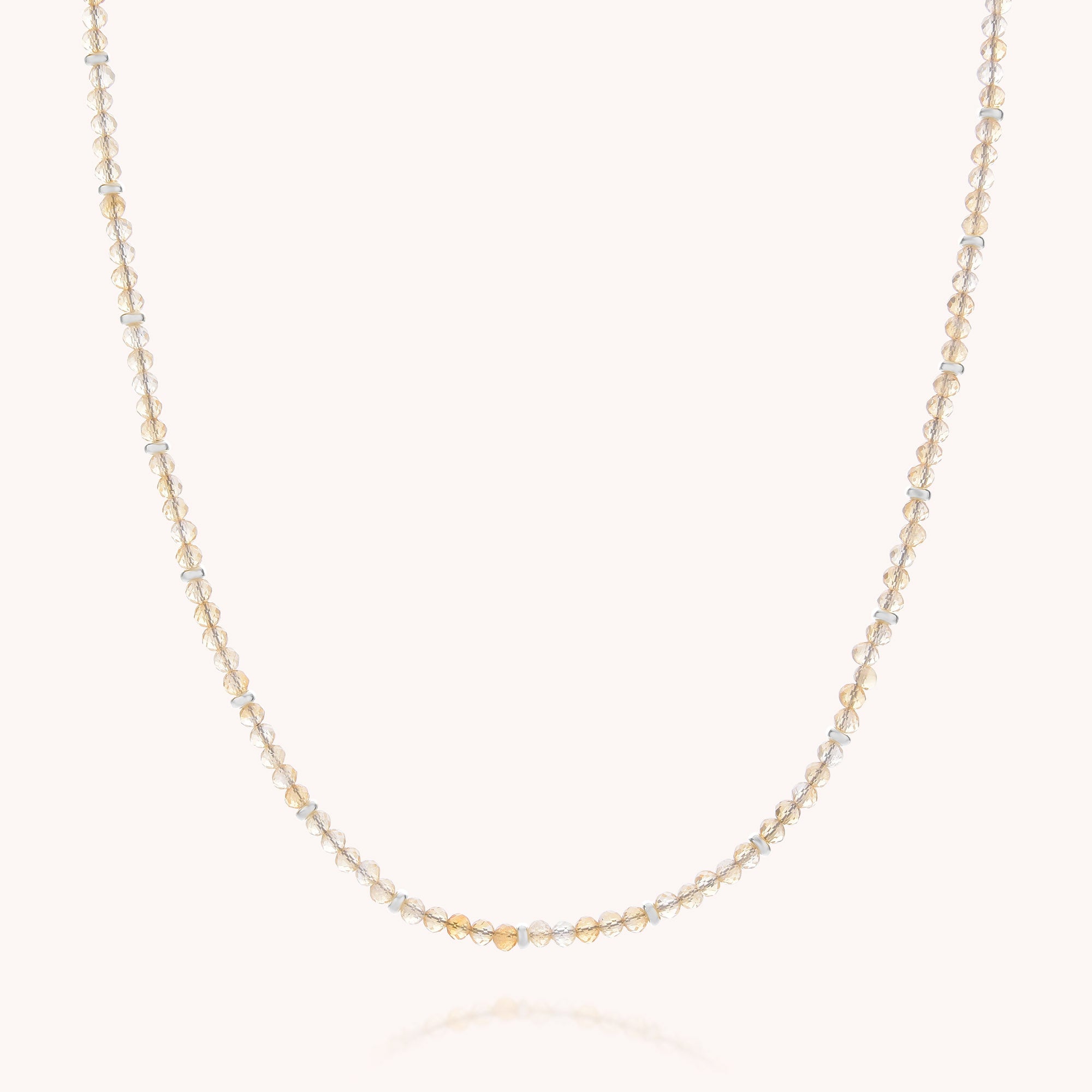 Citrine November Birthstone Orbit Necklace featuring delicately spaced small, round beads in shades of gold and silver along a thin, transparent string, displayed against a plain white background—an exquisite piece of handcrafted jewelry that makes an elegant addition to any collection.