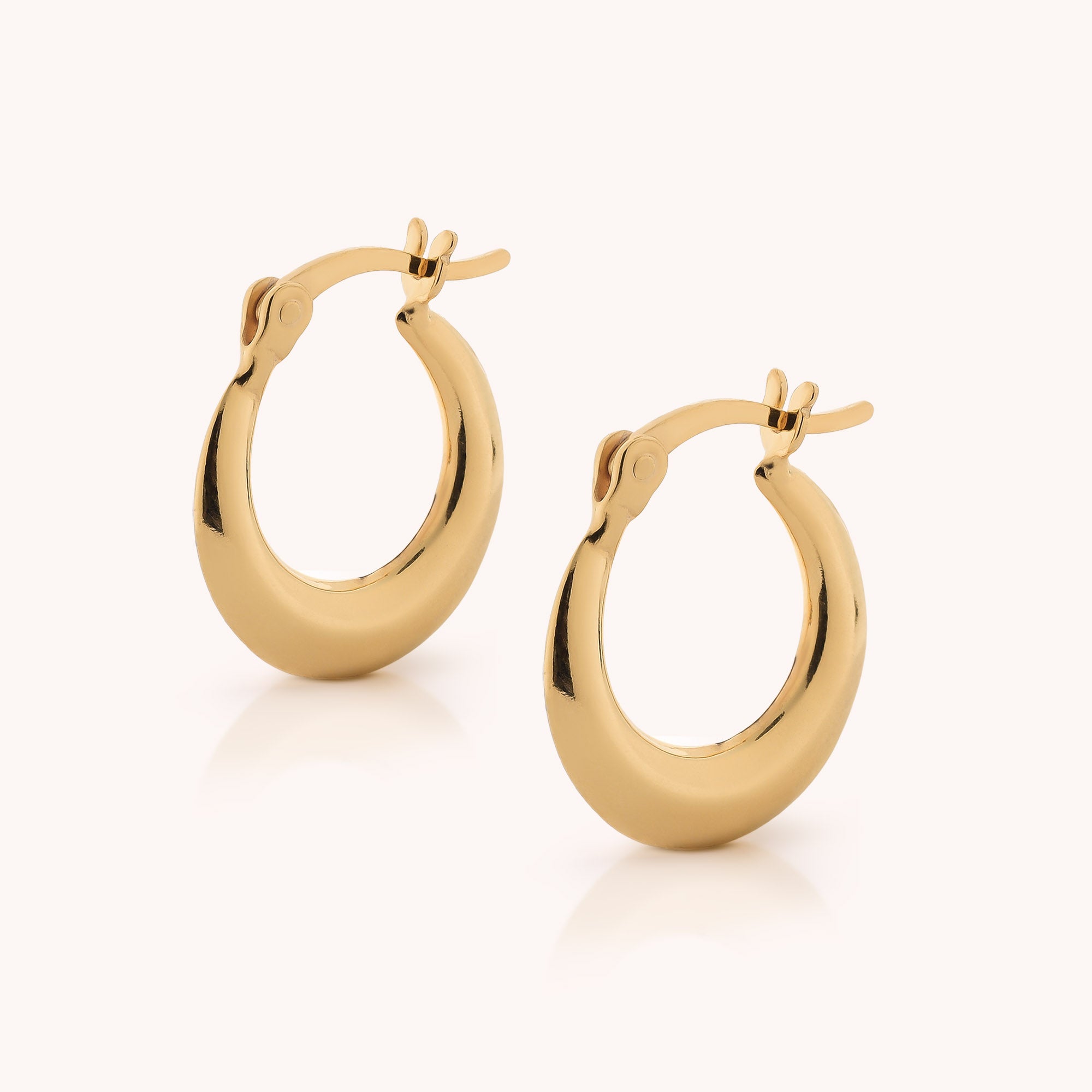 A pair of shiny, small Contour Hoop Earrings in gold, featuring latch back closures, displayed on a plain light background.