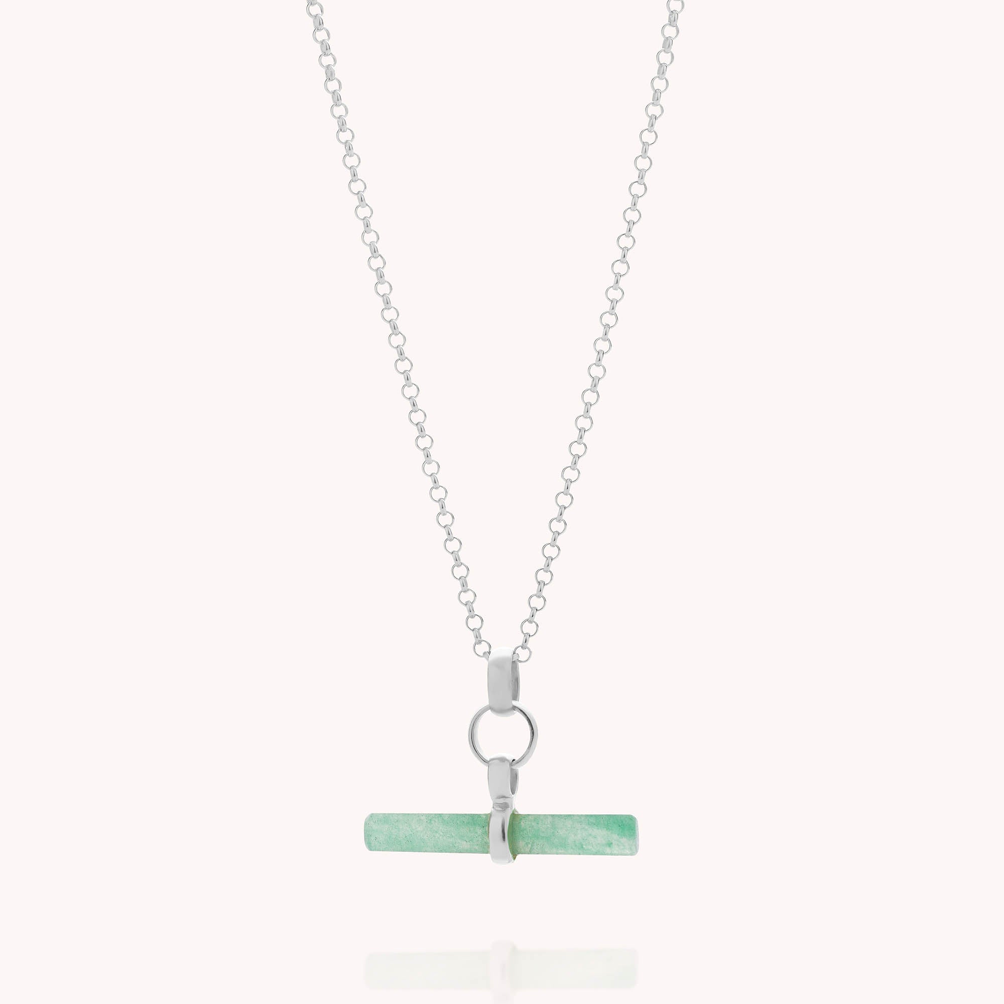 The Gemstone T Bar Necklace features a silver chain with a horizontal light green semi-precious stone pendant, secured by a small silver ring and clasp.