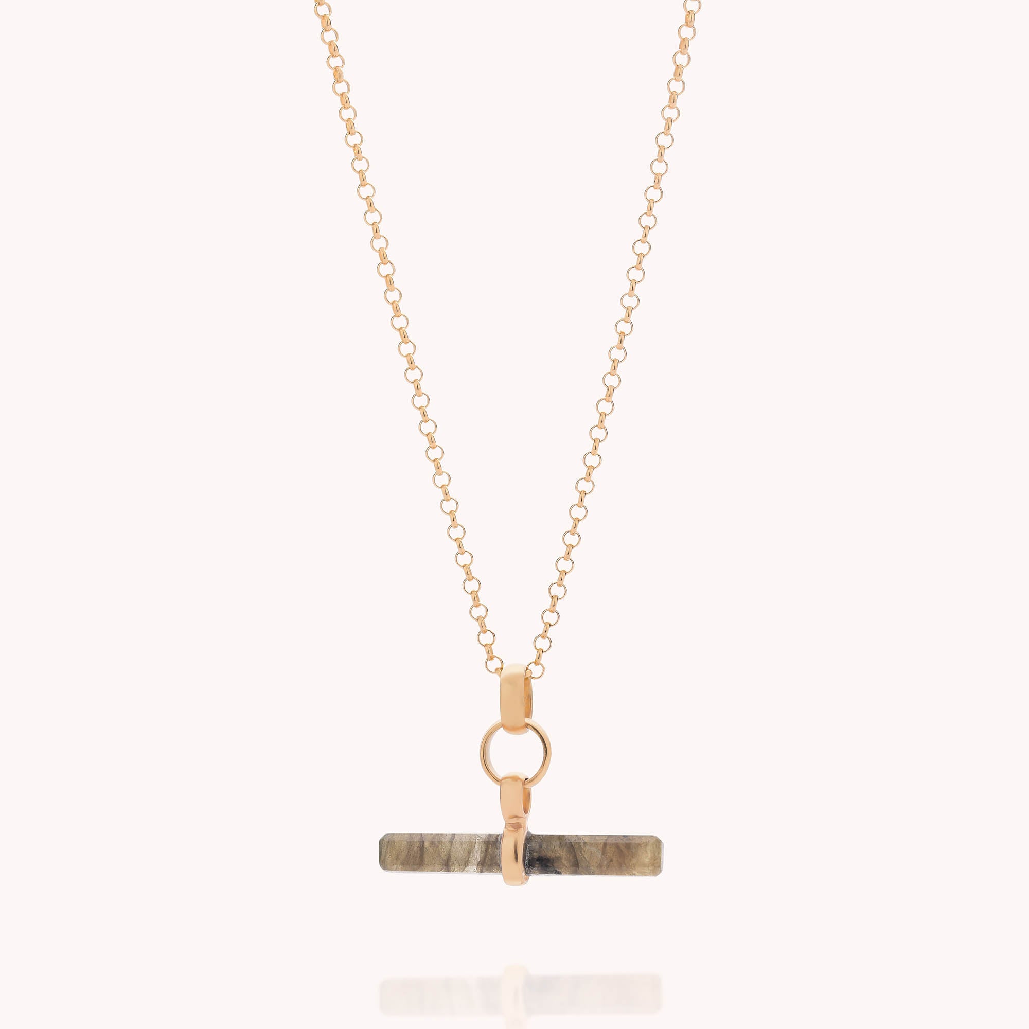 The Gemstone T Bar Necklace features a gold chain with a horizontal, rectangular gemstone pendant in neutral tones and a gold clasp, creating a modern twist on the classic gemstone necklace.