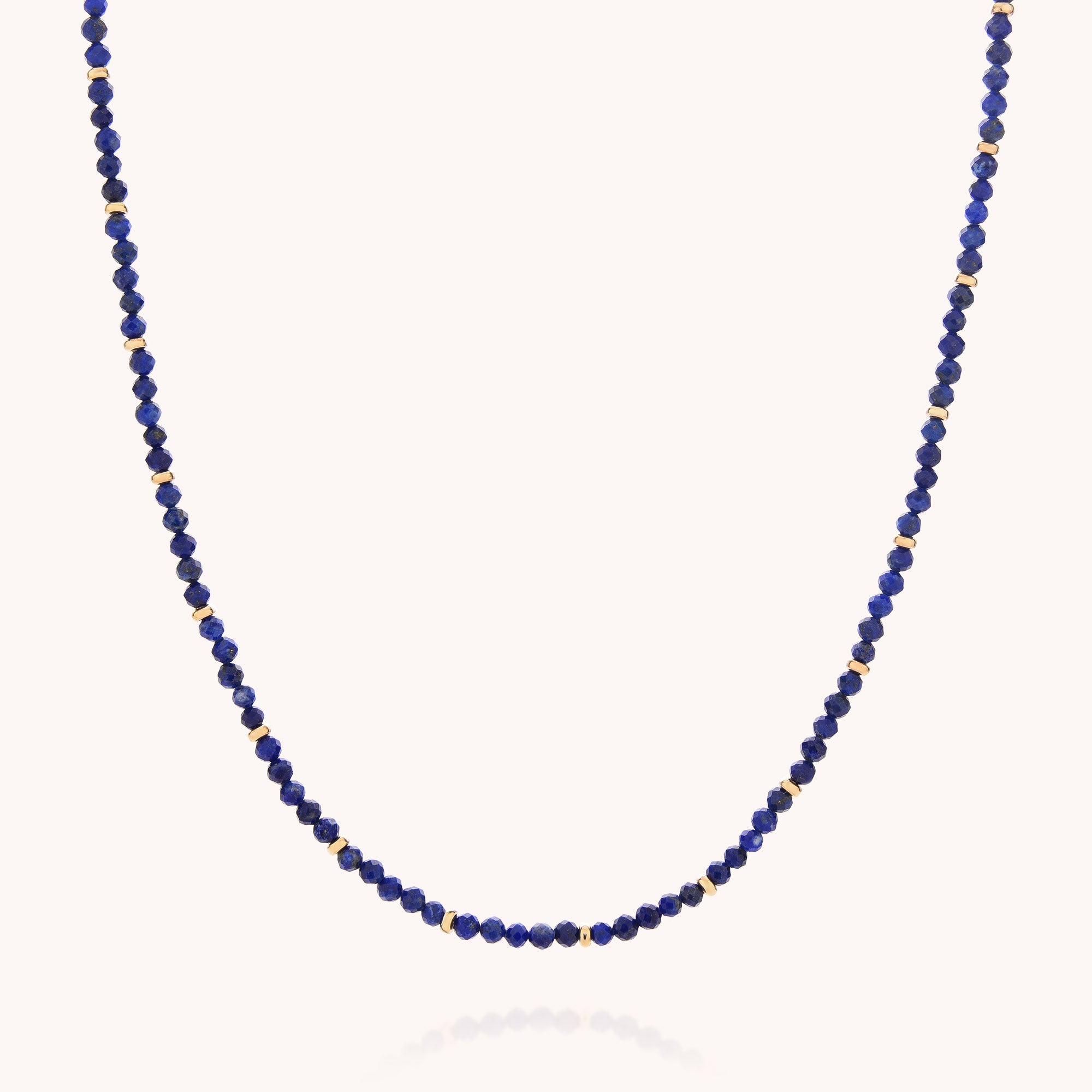 Introducing the Lapis September Birthstone Orbit Necklace—a delicate piece featuring alternating small round blue lapis and gold beads, beautifully displayed against a plain white background. This handcrafted jewelry is the perfect touch of elegance for everyday wear.