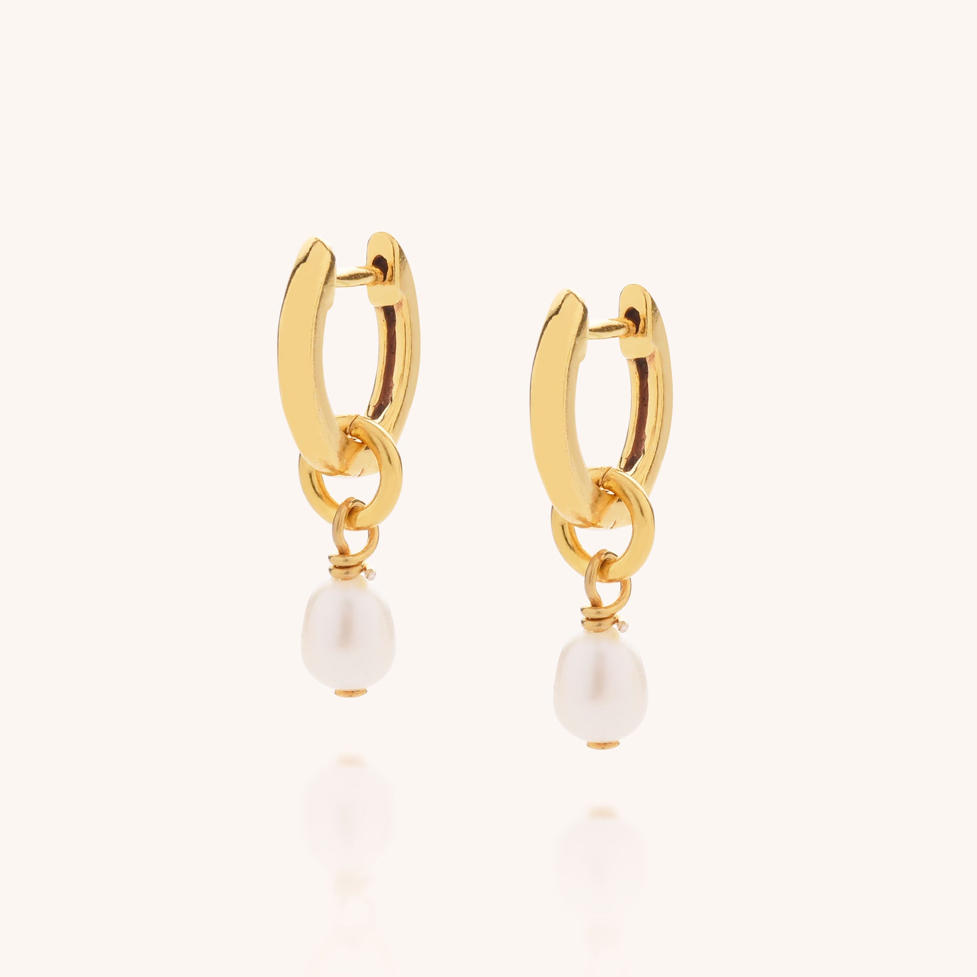 Mini white freshwater pearls dropped from a gold ear hoop