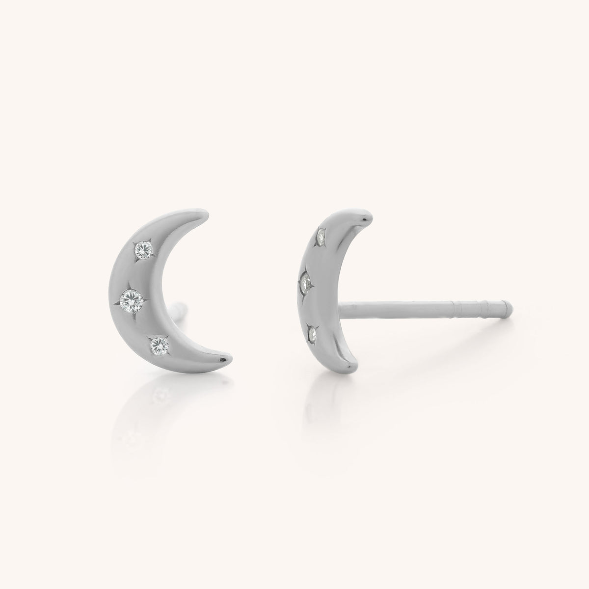 Starlit Moon Stud Earrings crafted in sterling silver, featuring delicate cubic zirconia accents embedded throughout. Displayed from front and side angles against a light background.