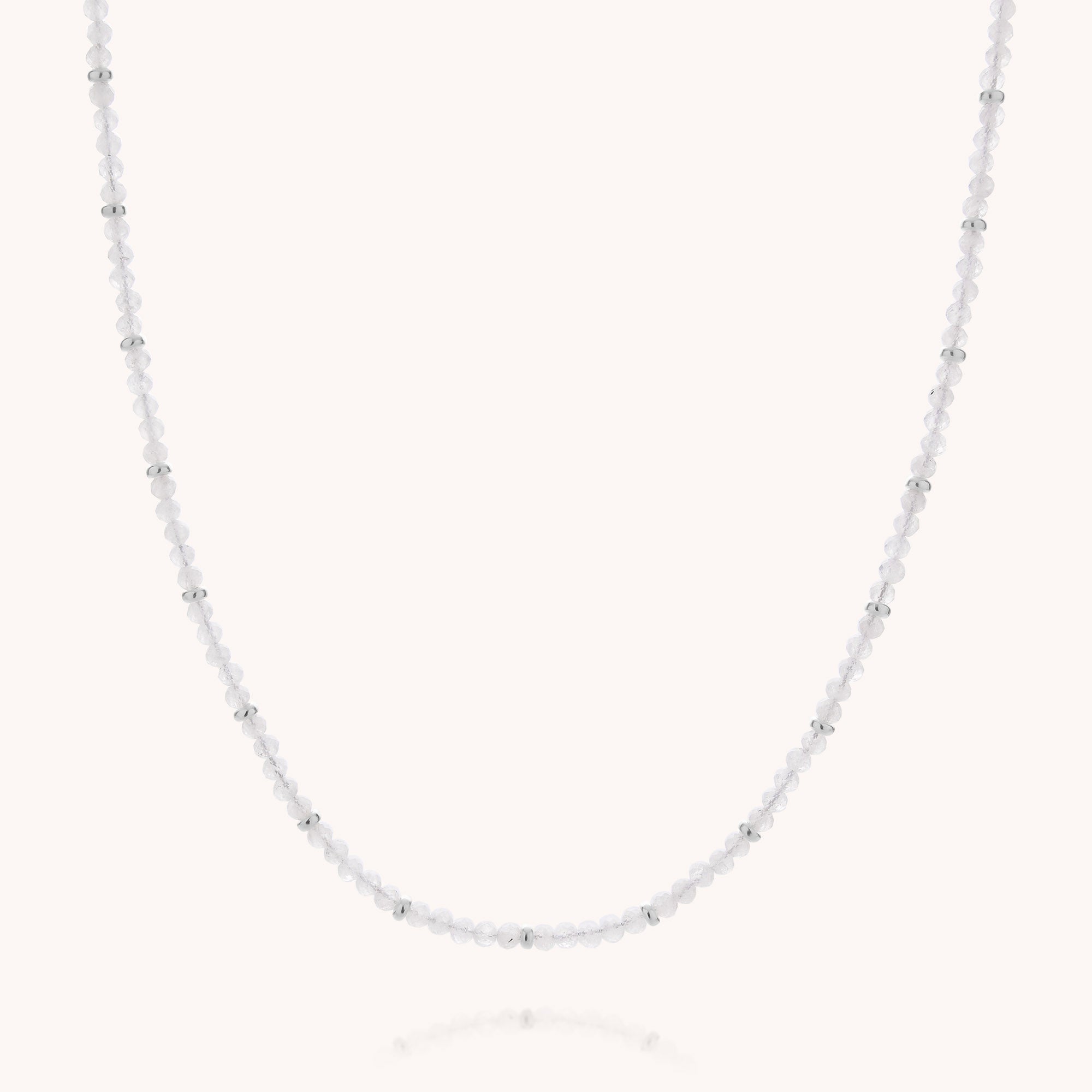 Introducing the Rainbow Moonstone June Birthstone Orbit Necklace—a delicate, handcrafted piece featuring small round white beads accented with occasional silver beads, arranged in a simple, elegant pattern against a plain white background. Perfect as a subtle rainbow moonstone accessory or a thoughtful June birthstone gift.