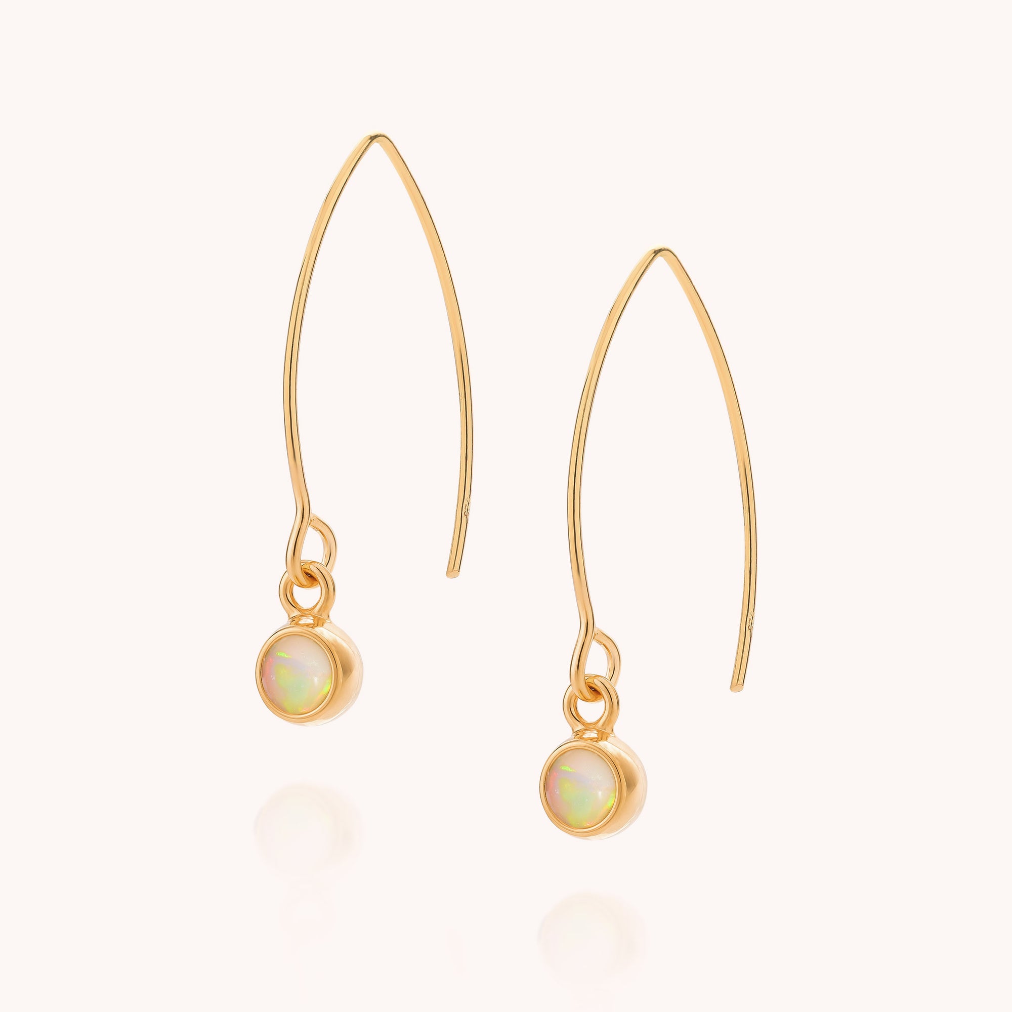 Ethiopian Opal Gem Dot Arc Earrings featuring gold drop hooks with a small round Ethiopian opal gemstone bezel-set at the base. The plain, light background emphasizes the delicate and elegant design of these exquisite October birthstone earrings.