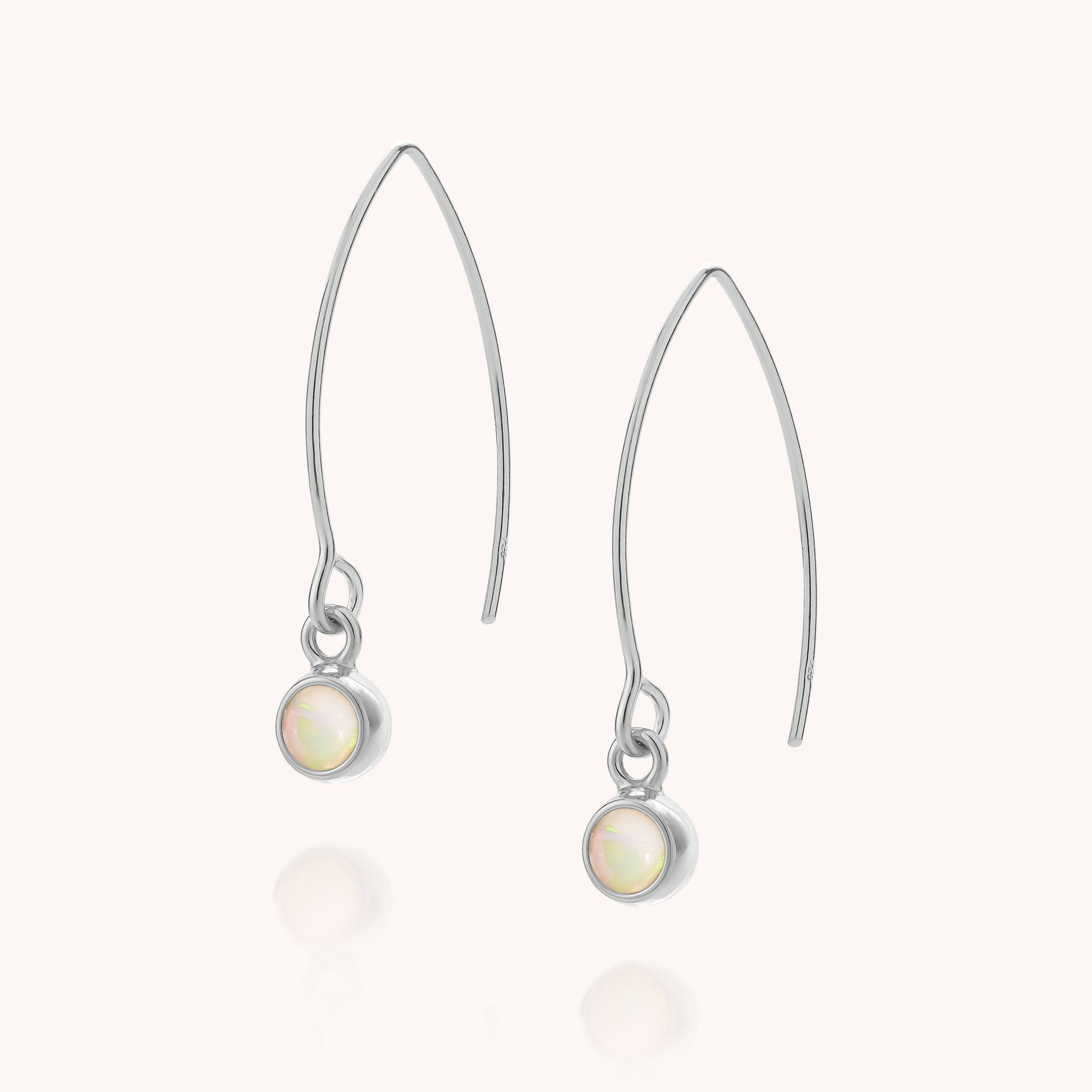 A pair of Ethiopian Opal Gem Dot Arc Earrings featuring delicate hooks and round Ethiopian opal gemstones set at the ends, displayed on a plain white background. These striking earrings, perfect for October birthdays, add a subtle, iridescent shimmer to any look.