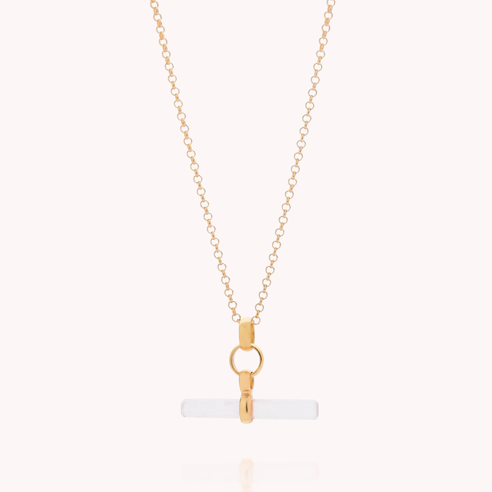 The Gemstone T-Bar Necklace - Quartz features a horizontal cylindrical quartz pendant with gold hardware, displayed on a plain light background.