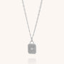 The Golden Dawn Necklace is a sterling silver piece with a rectangular sunburst pendant, displayed on a delicate oval-link chain that holds the center pendant vertically against a plain light background.