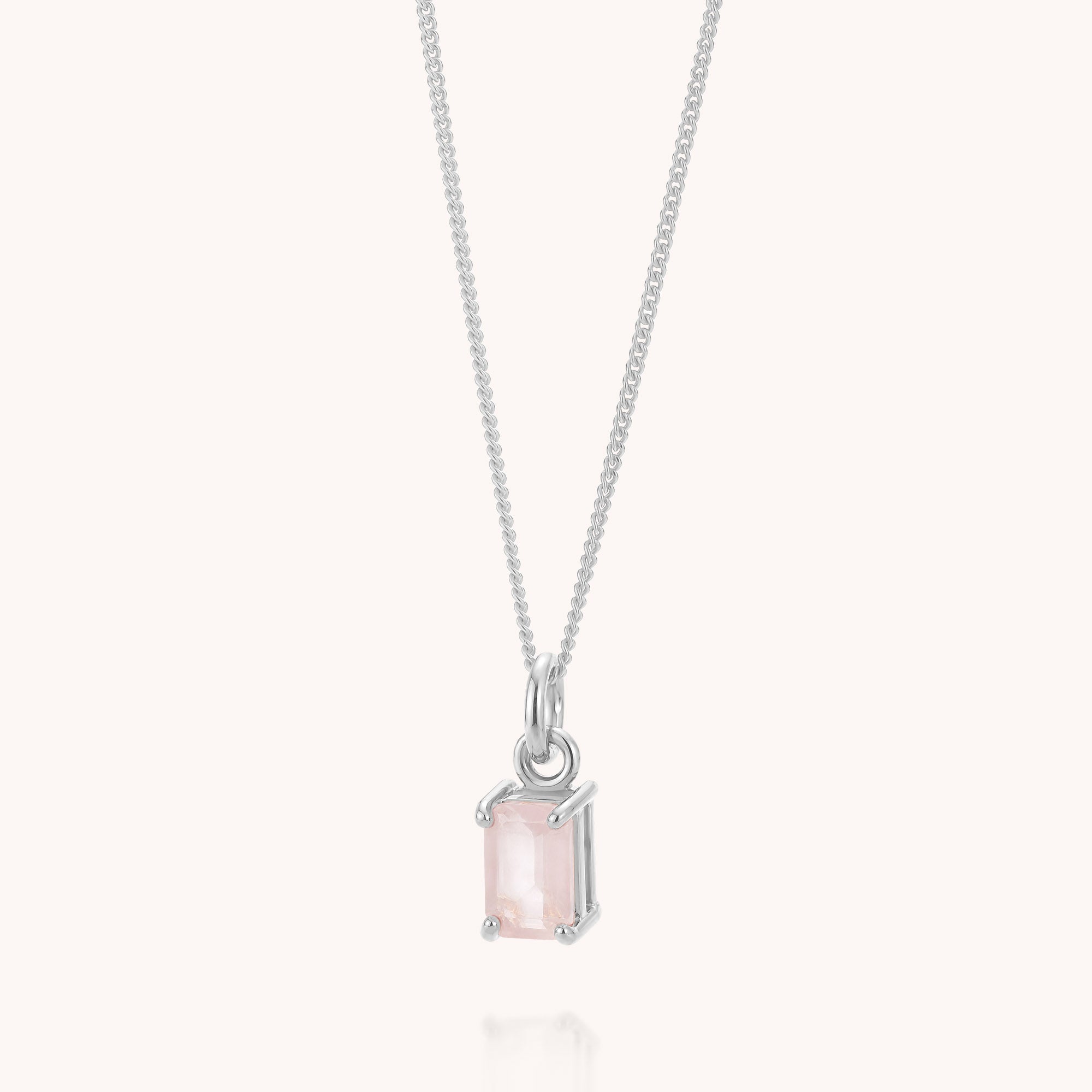 Introducing the Rose Quartz Octavia Necklace—a delicate sterling silver piece featuring a rectangular, pale pink rose quartz gemstone pendant in a simple prong setting, displayed on a light background. This timeless necklace is perfect for any occasion.