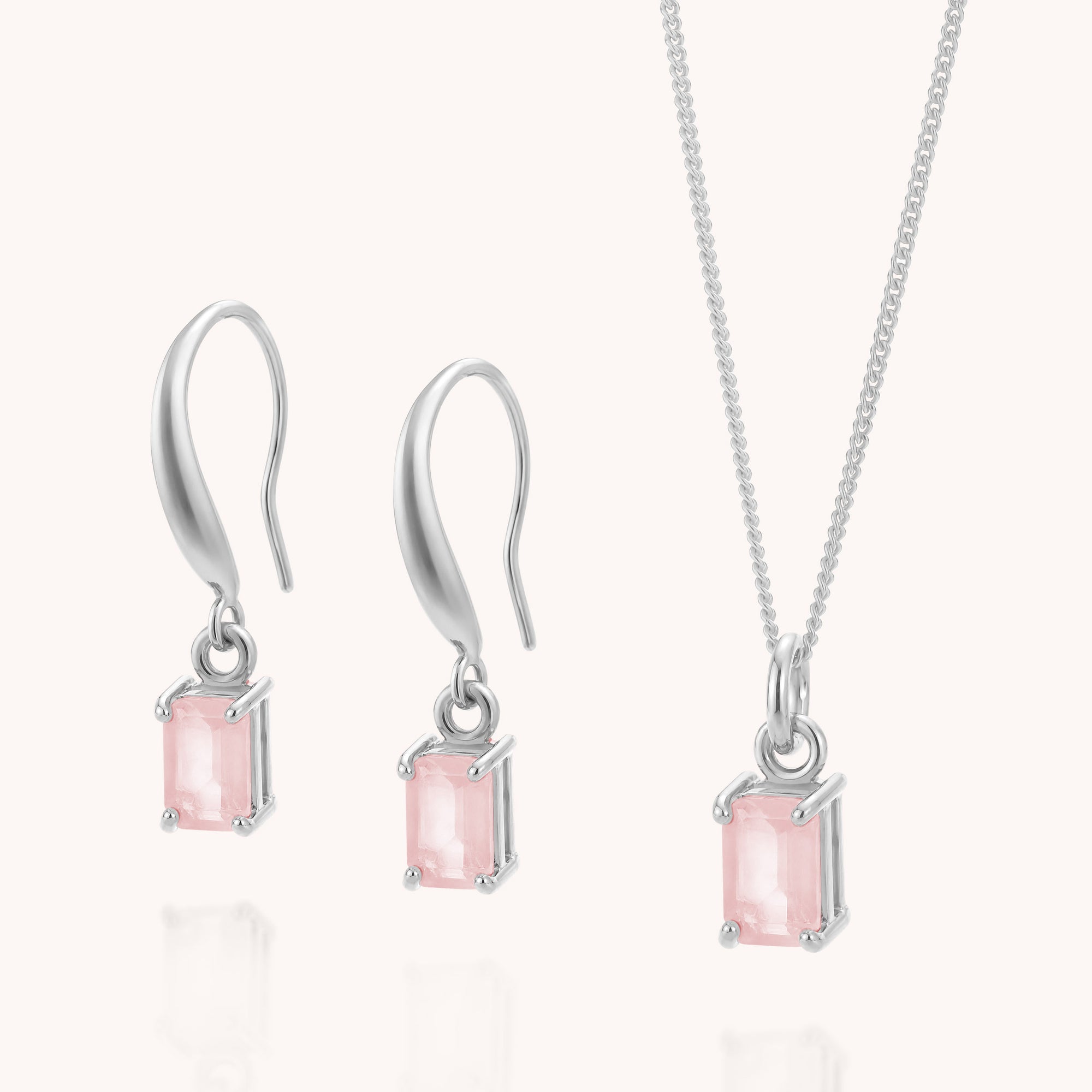 The Rose Quartz Octavia Necklace & Earrings Set features silver drop earrings and a matching necklace, each showcasing a rectangular light pink rose quartz gemstone in a prong setting on fine sterling silver chains and hooks—ideal for those seeking the delicate elegance of rose quartz jewellery.