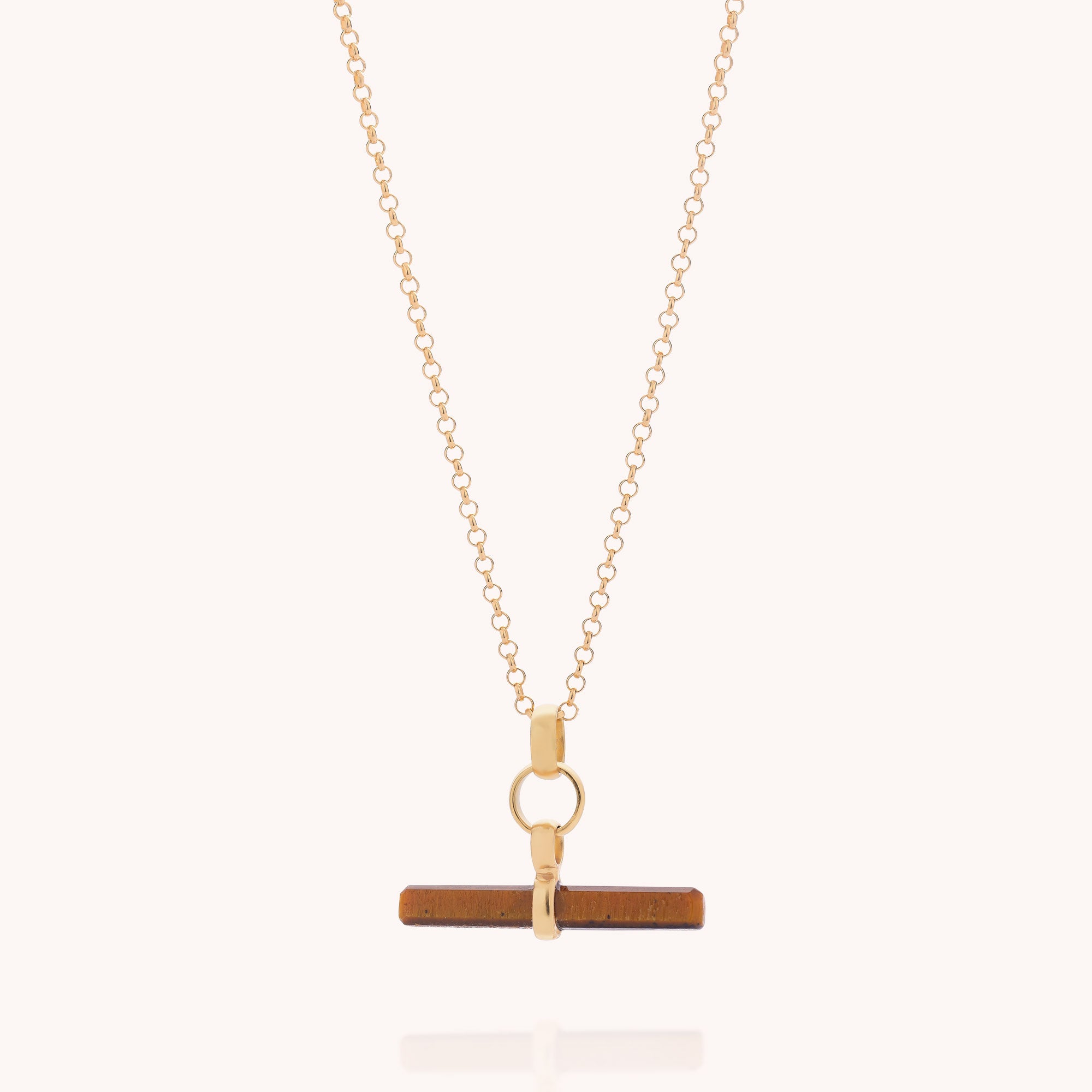 The Tiger Eye T-Bar Necklace features a gold plated sterling silver chain with a circular clasp, showcasing a horizontal brown tiger eye pendant, photographed against a plain, light background.