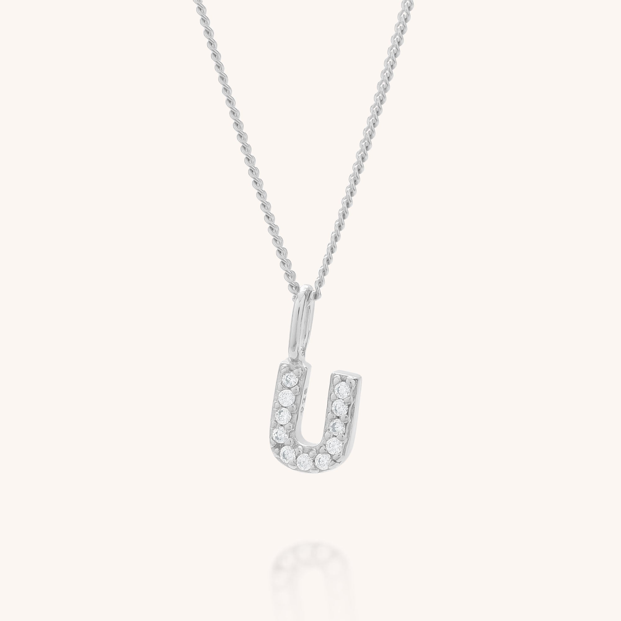 The Initial Sparkle Necklace is a personalised necklace with a silver U-shaped pendant set with sparkling cubic zirconia, shown on a simple, light background.